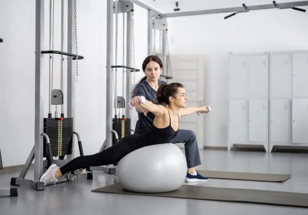 Physiotherapist Training woman in rehabilitation center