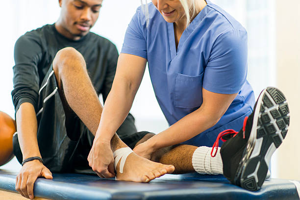 An athlete receiving rehibilitative care for a sports injury.